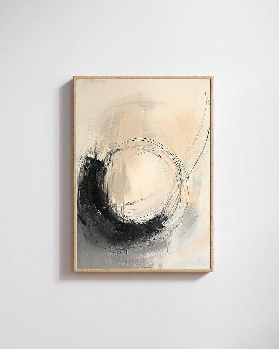 Abstract art piece with black and beige colors in a gold frame on a light gray wall.