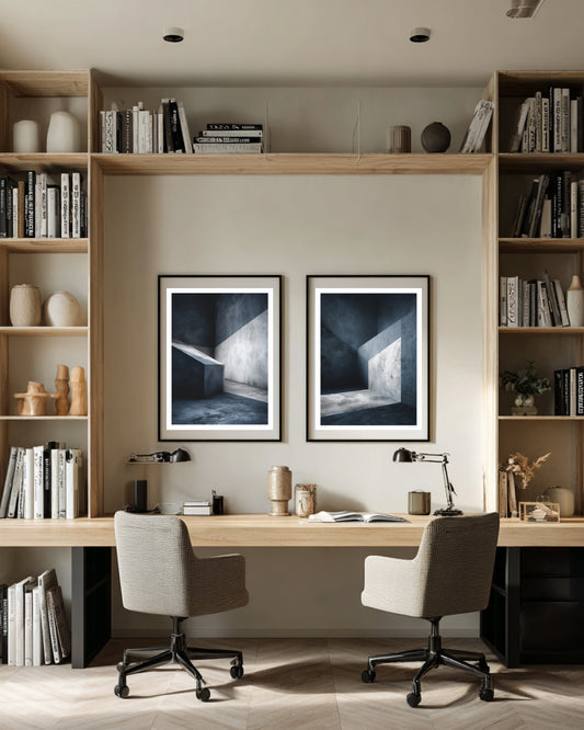 Modern home office with bookshelves, desk, and framed artwork.