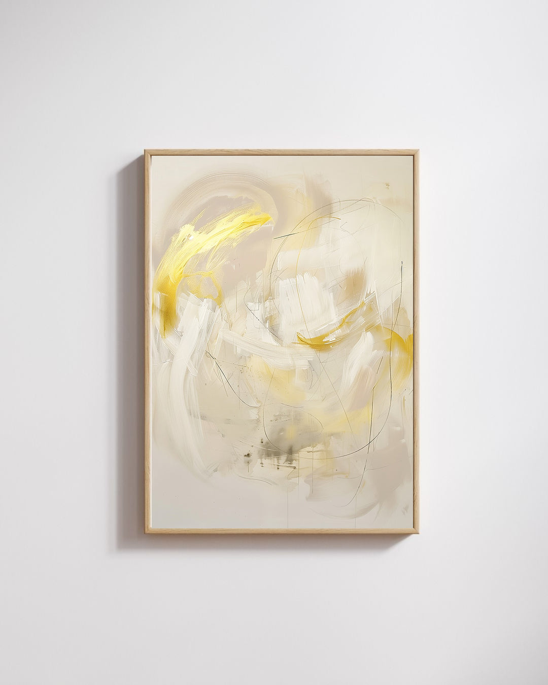 Abstract art piece with gold and white colors in a gold frame on a light gray wall.